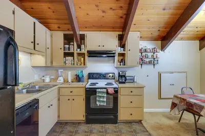 a kitchen with a stove top oven next to a sink at Pinecrest Dodge Ridge Cabin Shared Outdoor Space in Cold Springs
