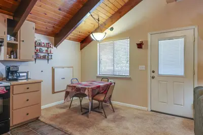 a kitchen with a table and chairs in a room at Pinecrest Dodge Ridge Cabin Shared Outdoor Space in Cold Springs