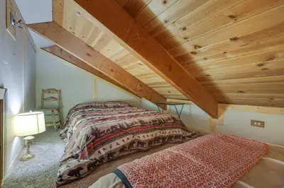 a bed in a room with a wooden ceiling at Pinecrest Dodge Ridge Cabin Shared Outdoor Space in Cold Springs