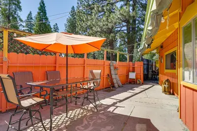a table and chairs with an umbrella on a patio at Pinecrest Dodge Ridge Cabin Shared Outdoor Space in Cold Springs
