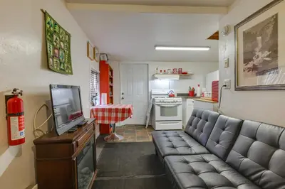 a living room with a couch and a kitchen at Dodge Ridge Pinecrest Mountain Cabin Near Hiking! in Cold Springs