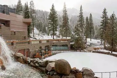 a pool of snow in front of a building with a waterfall at 556 Everline in Olympic Valley