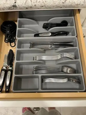 a drawer filled with silver utensils in a drawer at Brand-New, Beautiful & Stylish Home in Sacramento! in Sacramento