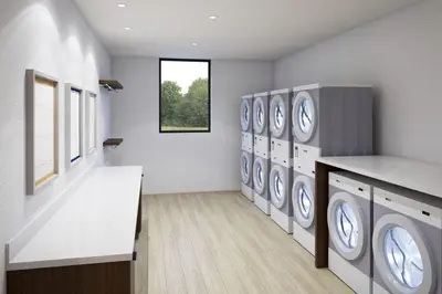 a laundry room with a row of washers and dryers at Staybridge Suites Manteca by IHG in Manteca