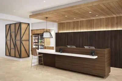 a restaurant with a counter and a chair in a room at Staybridge Suites Manteca by IHG in Manteca