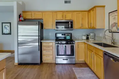 a kitchen with stainless steel appliances and wooden cabinets at Truckee Retreat with Fireplace and Community Amenities in Truckee