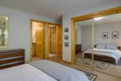 a bedroom with a bed and a mirror at Truckee Retreat with Fireplace and Community Amenities in Truckee