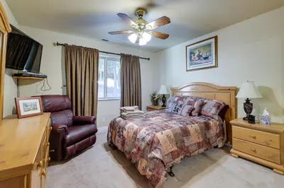 a bedroom with a bed and a dresser and a television at Groveland Vacation Rental Near Pine Mountain Lake! in Groveland