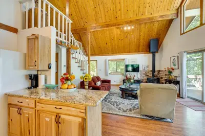 a kitchen and living room with wooden ceilings at Groveland Vacation Rental about 26 Miles to Yosemite! in Groveland