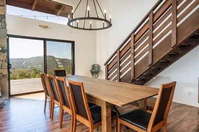 a dining room with a wooden table and chairs at Yosemite Sunrise House with hot tub/views/game room in Oakhurst