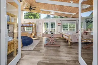 a large living room with a wooden ceiling at Yosemite Creekside Retreat with spa/games/EV Charger and more in Oakhurst