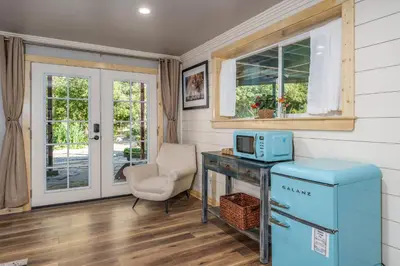 a home office with a blue refrigerator and a chair at Yosemite Creekside Retreat with spa/games/EV Charger and more in Oakhurst