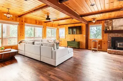 a living room with a couch and a fireplace at Sequoia Retreat- Spacious Cabin, Hot tub, & Sundeck in Ponderosa