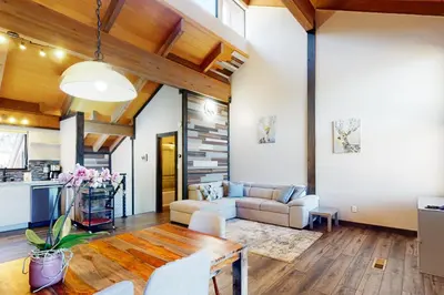 a living room with a table and a couch at Rocky Point Paradise in Truckee