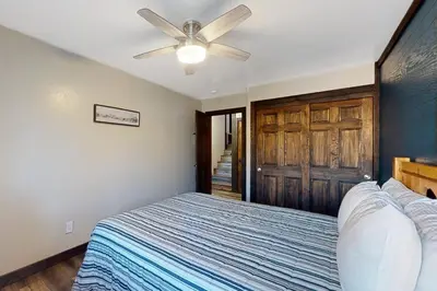 a bedroom with a bed and a ceiling fan at Rocky Point Paradise in Truckee