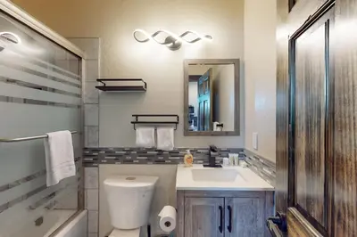 a bathroom with a toilet and a sink and a mirror at Rocky Point Paradise in Truckee