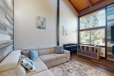 a living room with a couch and a window at Rocky Point Paradise in Truckee