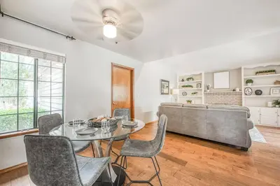 a living room with a table and chairs and a couch at Stylish 3BR/2BA Retreat w/ Pool! Dream Getaway in Fresno