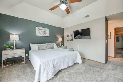 a bedroom with a bed and a ceiling fan at Stylish 3BR/2BA Retreat w/ Pool! Dream Getaway in Fresno