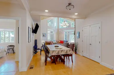 a dining room and living room with a table at Granite Tranquility in Yosemite West