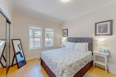 a bedroom with a bed and two windows at Granite Tranquility in Yosemite West