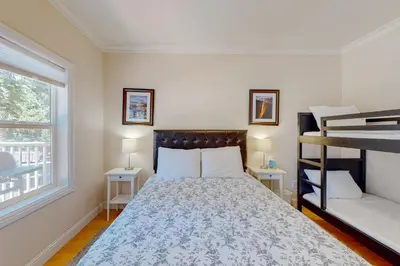 a bedroom with a bed and two night stands at Granite Tranquility in Yosemite West