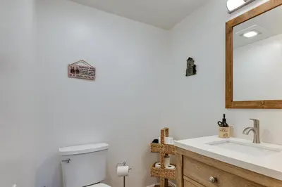 a bathroom with a sink and a mirror at Mi-Wuk Village Vacation Rental with Multi-Level Deck in Mi-Wuk Village