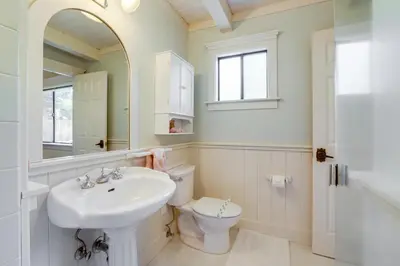 a bathroom with a sink and a toilet and a mirror at 2 Mi to Lake Tahoe Spacious and Serene Retreat! in Tahoe City