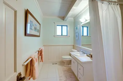 a bathroom with a toilet and a sink and a mirror at 2 Mi to Lake Tahoe Spacious and Serene Retreat! in Tahoe City