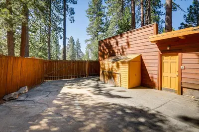 a building with a yellow door next to a fence at 2 Mi to Lake Tahoe Spacious and Serene Retreat! in Tahoe City