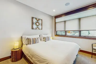 a bedroom with a white bed and a window at Red Mountain Lodge in Truckee