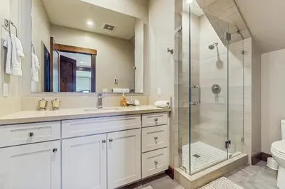 a bathroom with a shower and a sink and a toilet at Red Mountain Lodge in Truckee