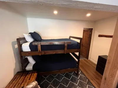 a small room with two bunk beds in it at Cozy Ski Condo - Walk to Canyon - Dog Friendly in Mammoth Lakes