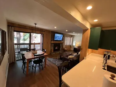 a kitchen and living room with a table and chairs at Cozy Ski Condo - Walk to Canyon - Dog Friendly in Mammoth Lakes