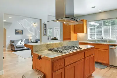 a kitchen with a stove top oven in a room at Near Dtwn Twain Harte Home with Furnished Deck! in Twain Harte