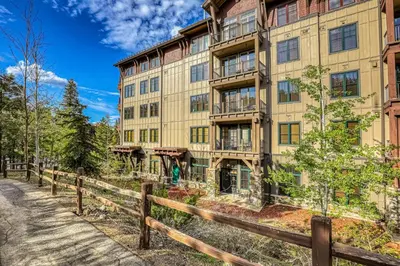 a large building with a fence in front of it at Snowscape Serenity in Truckee