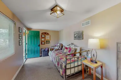 a bedroom with a bed and a blue door at Bass Lake Lodge in Bass Lake
