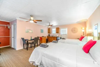 a bedroom with two beds and a dining room at Sequoia Studio with Private Patio in Visalia