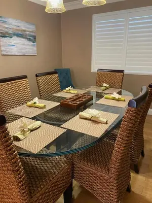 a dining room with a glass table and chairs at Group Retreat with Hot Tub & Studio in Visalia