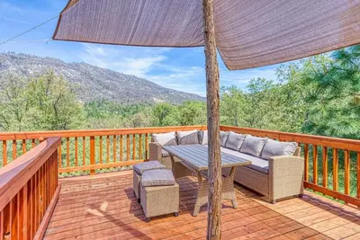 a patio with a table and chairs on a deck at 11 Acre Mountain Spirit Retreat in North Fork