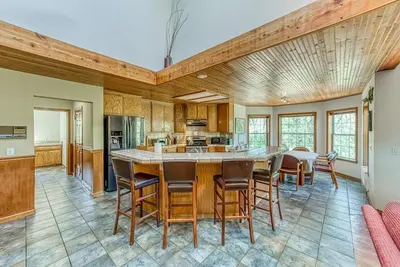 a kitchen with a large table and chairs in a room at 11 Acre Mountain Spirit Retreat in North Fork