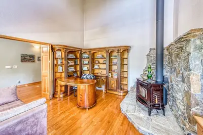 a living room with a fireplace and a wood stove at 11 Acre Mountain Spirit Retreat in North Fork
