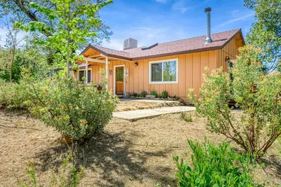 a house with a yard with trees at 11 Acre Mountain Spirit Retreat in North Fork
