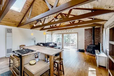 a kitchen and living room with a table and a stove at 11 Acre Mountain Spirit Retreat in North Fork