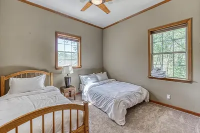 two beds in a bedroom with two windows at 11 Acre Mountain Spirit Retreat in North Fork