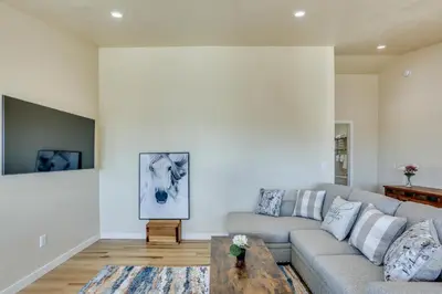 a living room with a couch and a table at Comfy Oakhurst Duplex Near Hiking and Sightseeing! in Oakhurst