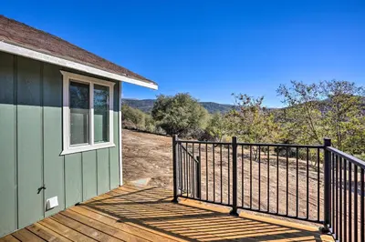 a porch of a green house with a window at Oakhurst Duplex about 13 Mi to Yosemite National Park! in Oakhurst