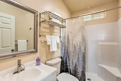 a bathroom with a sink and a toilet and a shower at Oakhurst Duplex about 13 Mi to Yosemite National Park! in Oakhurst