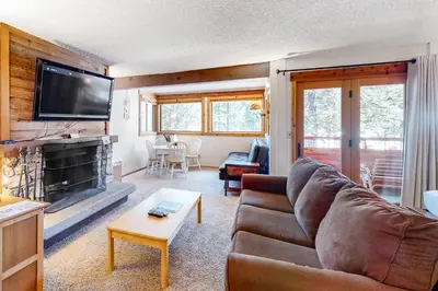 a living room with a couch and a fireplace at Master Units 18A & B at Granlibakken in Tahoe City