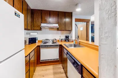 a kitchen with a sink and a stove top oven at Master Units 18A & B at Granlibakken in Tahoe City